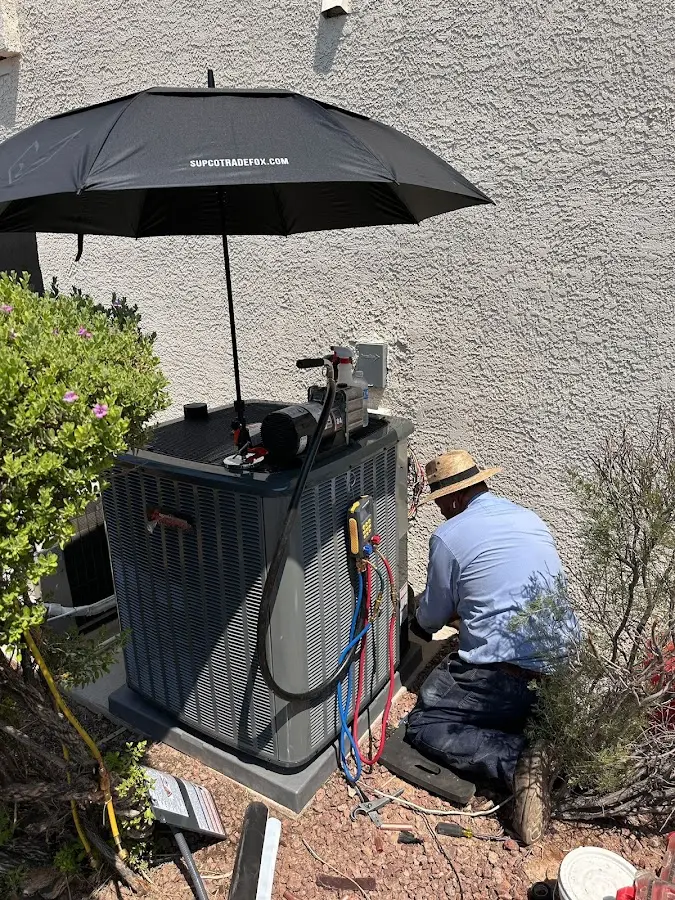 HVAC technician performing outdoor AC maintenance in La Verne