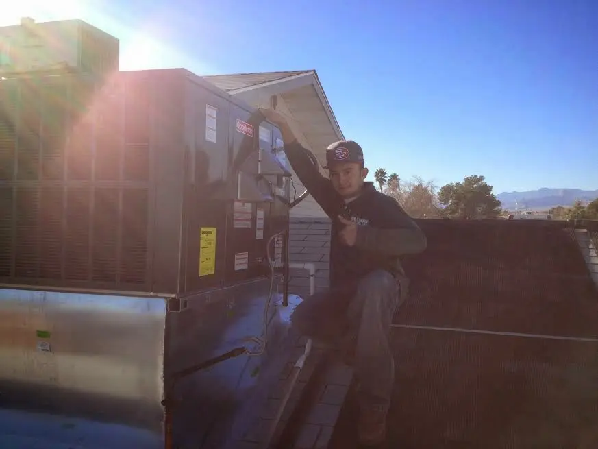 HVAC technician performing Boiler Repair on a rooftop unit in La Verne